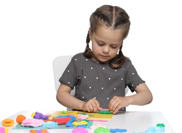 Little girl sculpting with play dough at table on white background