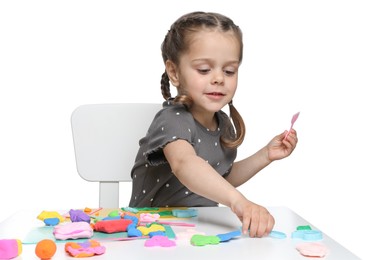 Photo of Little girl sculpting with play dough at table on white background