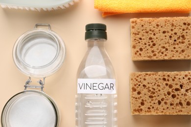 Photo of Eco friendly natural cleaners. Flat lay composition with bottle of vinegar on beige background