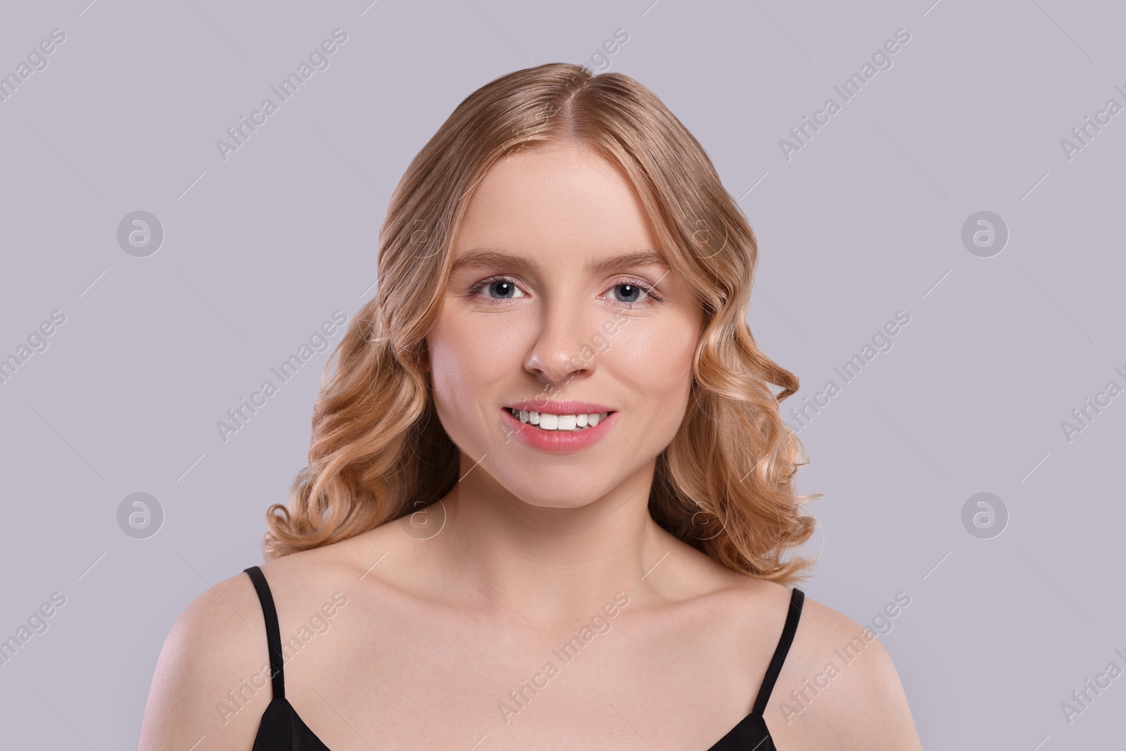 Photo of Portrait of beautiful woman with blonde hair on light grey background