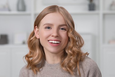 Portrait of beautiful woman with blonde hair indoors