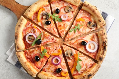 Photo of Cut delicious vegetarian pizza on light table, top view