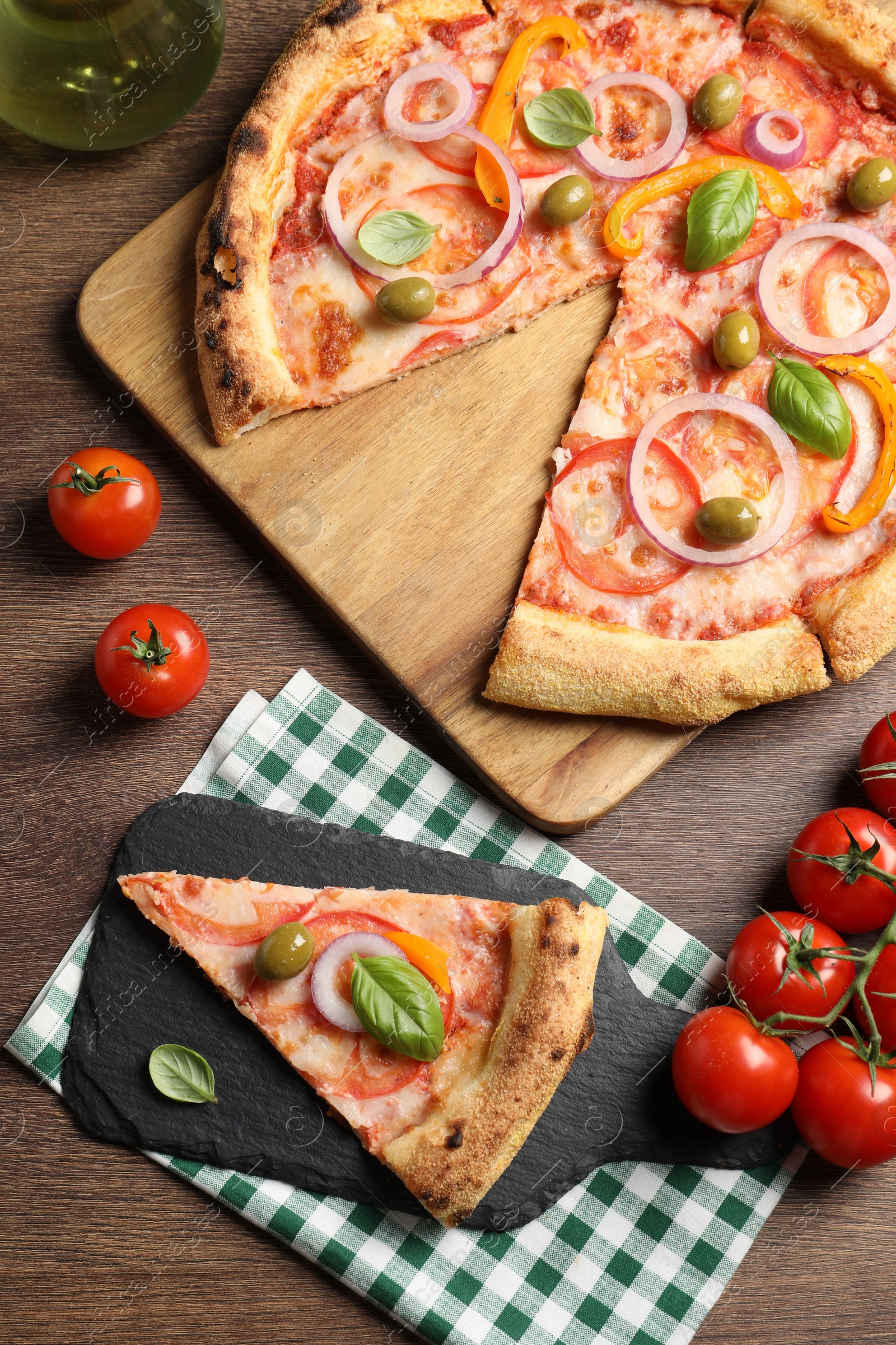 Photo of Delicious vegetarian pizza served on wooden table, flat lay