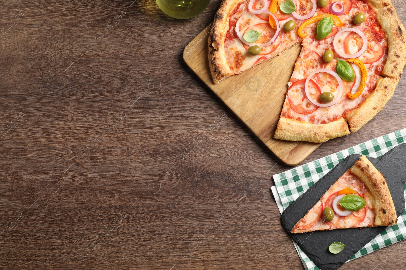 Photo of Delicious vegetarian pizza served on wooden table, flat lay. Space for text