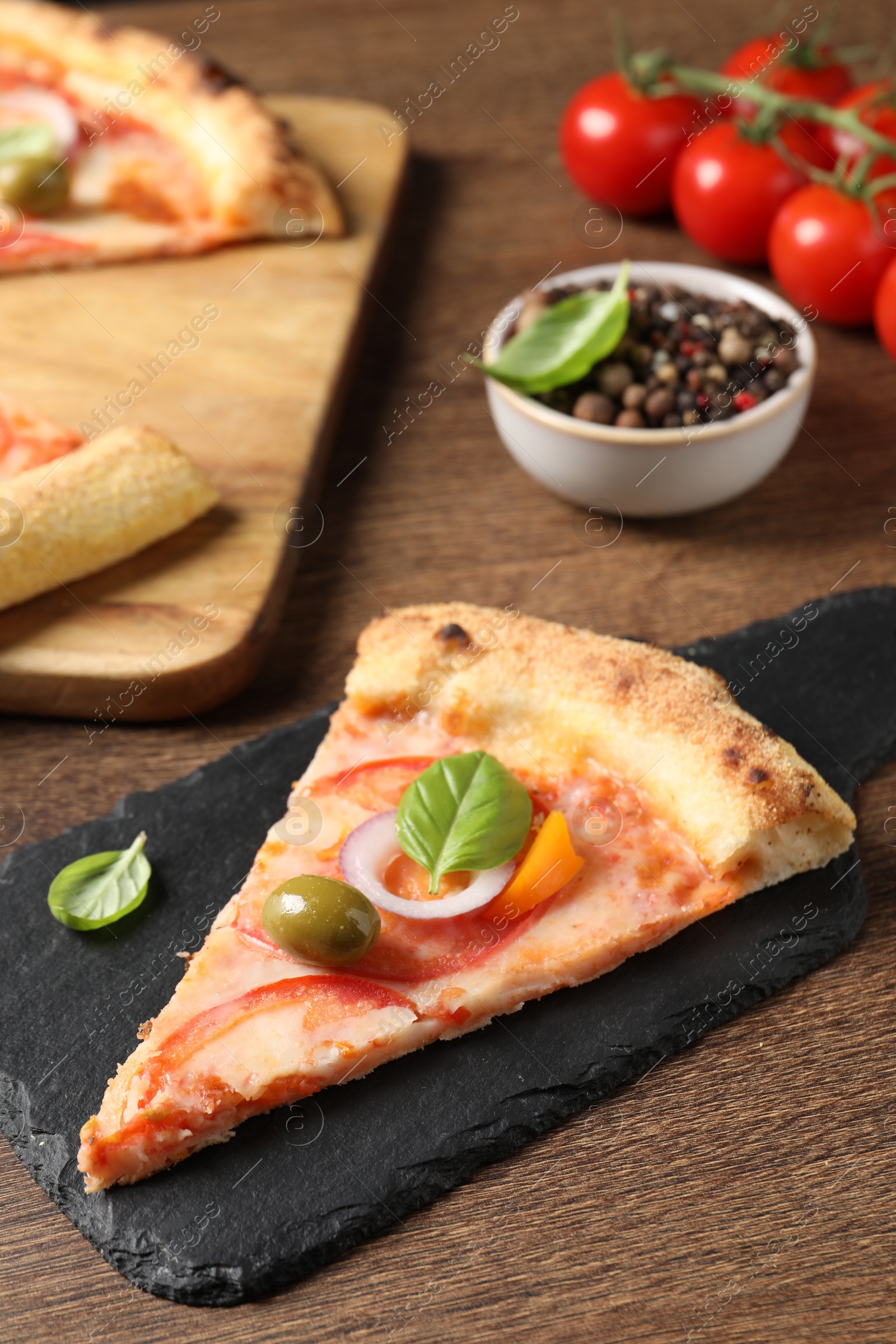 Photo of Slice of delicious vegetarian pizza on wooden table, closeup