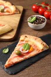 Photo of Slice of delicious vegetarian pizza on wooden table, closeup