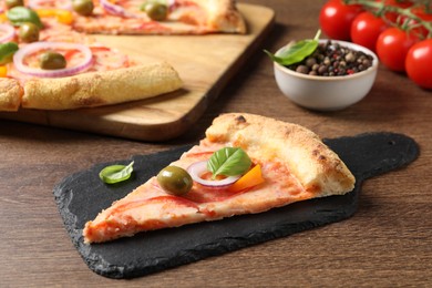 Photo of Slice of delicious vegetarian pizza on wooden table, closeup