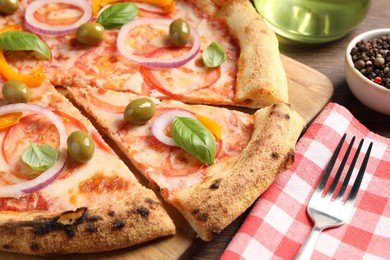 Photo of Delicious vegetarian pizza served on wooden table, closeup