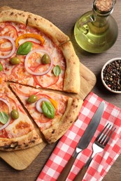 Photo of Delicious vegetarian pizza served on wooden table, flat lay