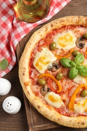 Photo of Delicious vegetarian pizza served on wooden table, flat lay