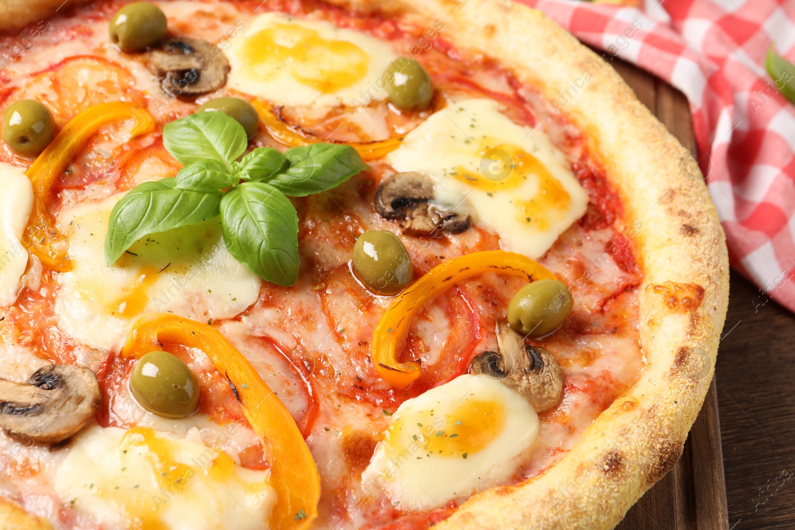 Photo of Delicious vegetarian pizza on wooden table, closeup