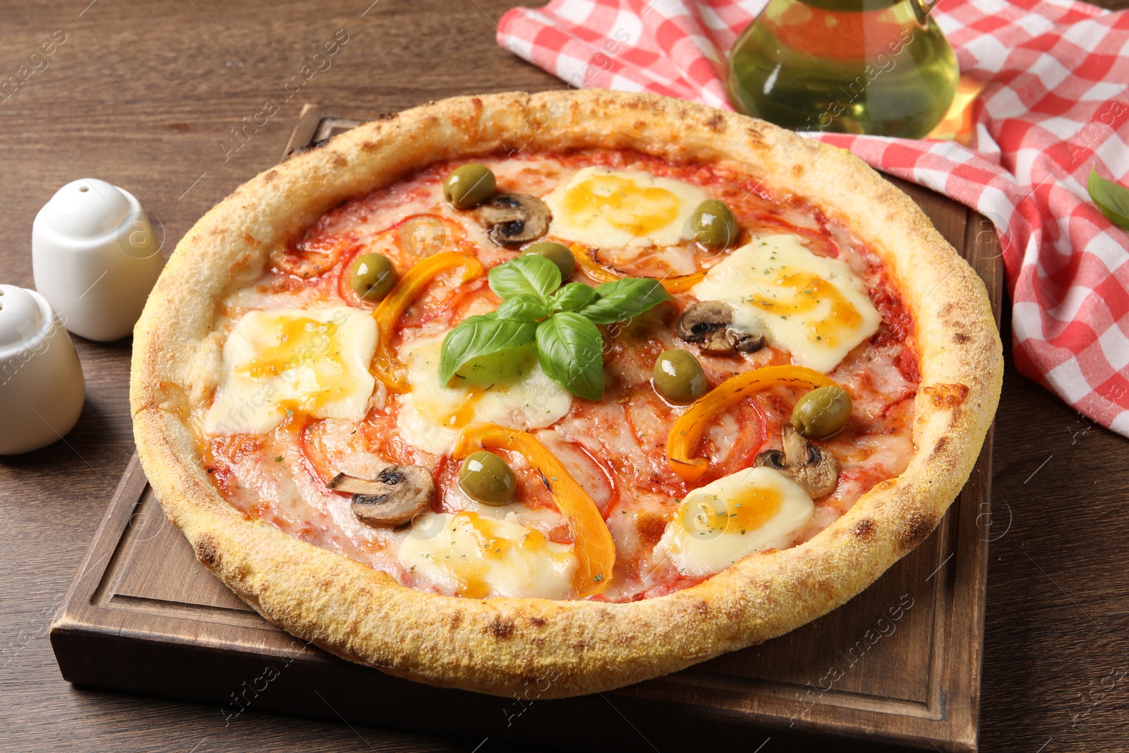 Photo of Delicious vegetarian pizza on wooden table, closeup