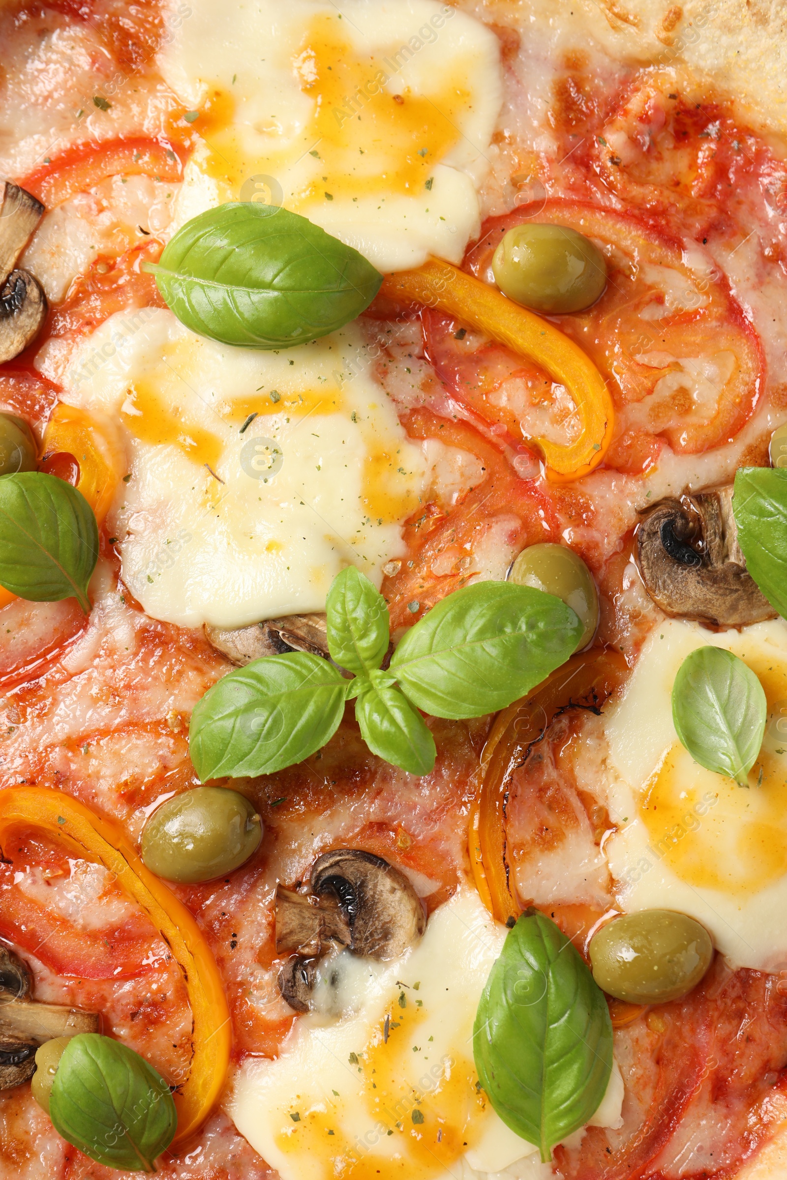 Photo of Delicious vegetarian pizza with basil as background, closeup