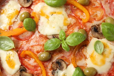 Photo of Delicious vegetarian pizza with basil as background, closeup