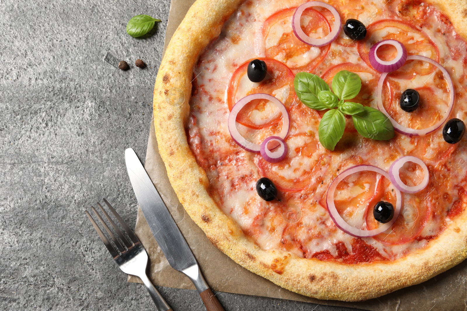 Photo of Delicious vegetarian pizza on grey table, top view