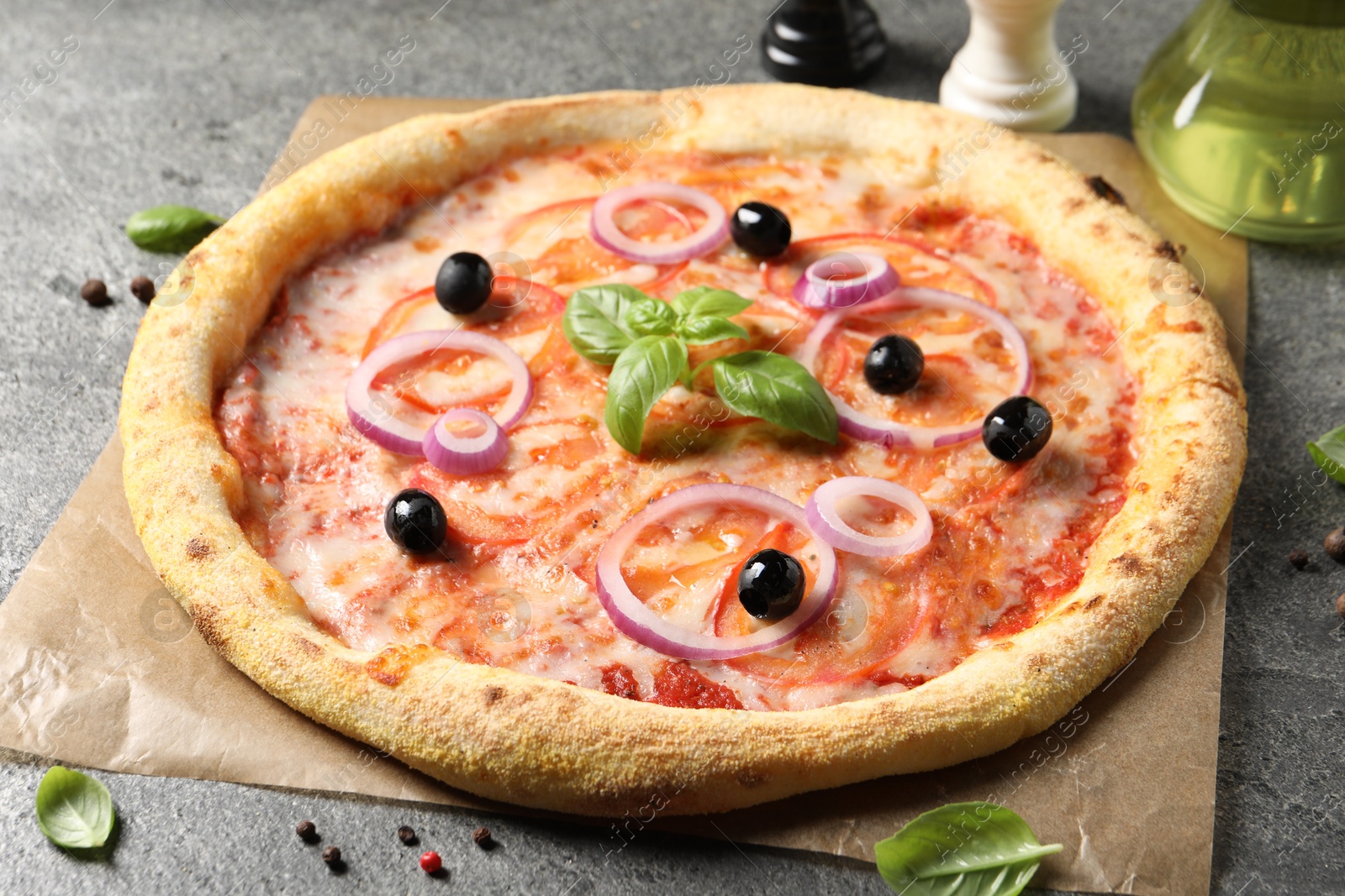 Photo of Delicious vegetarian pizza on grey table, closeup