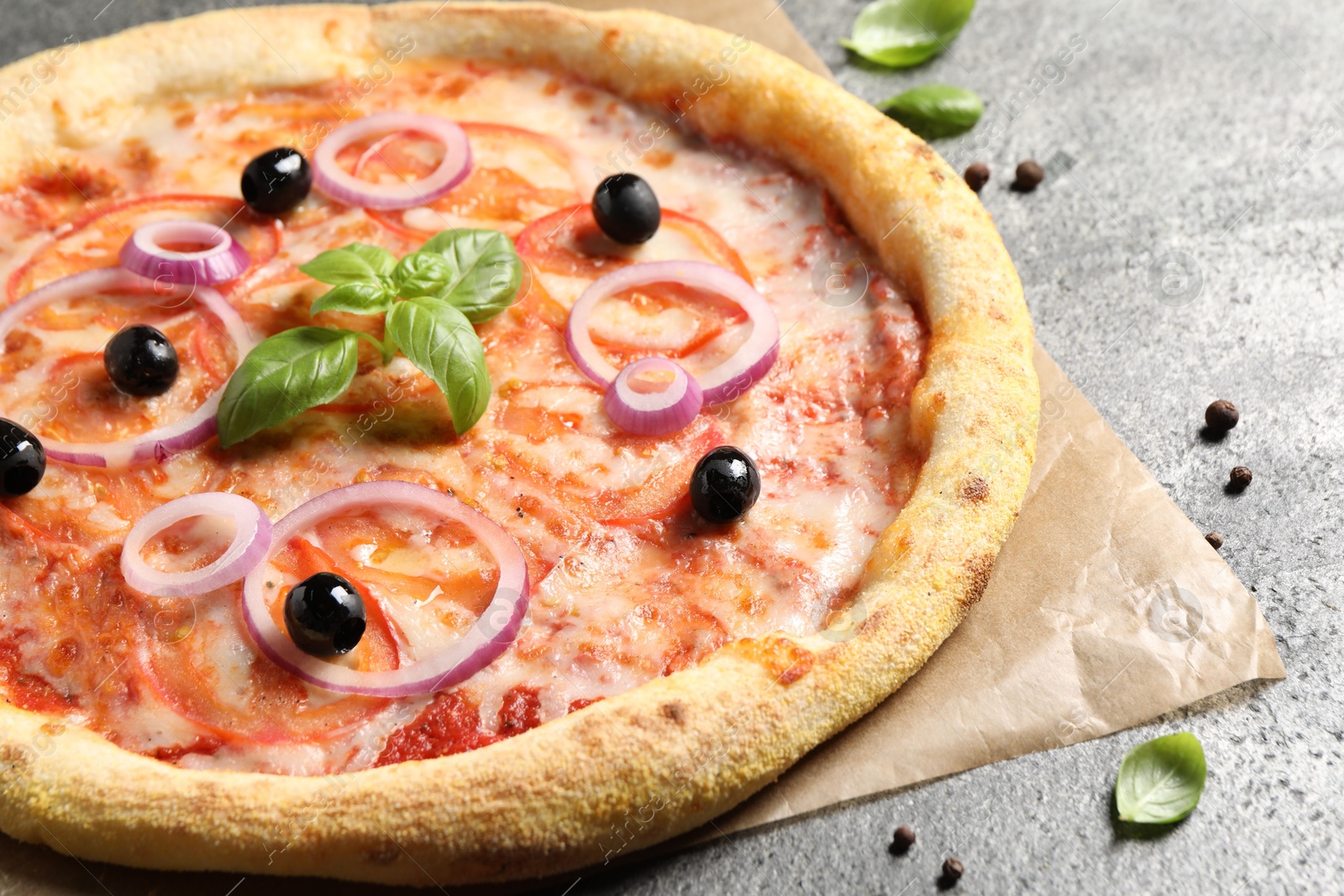 Photo of Delicious vegetarian pizza on grey table, closeup