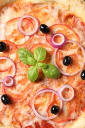 Photo of Delicious vegetarian pizza with basil as background, closeup