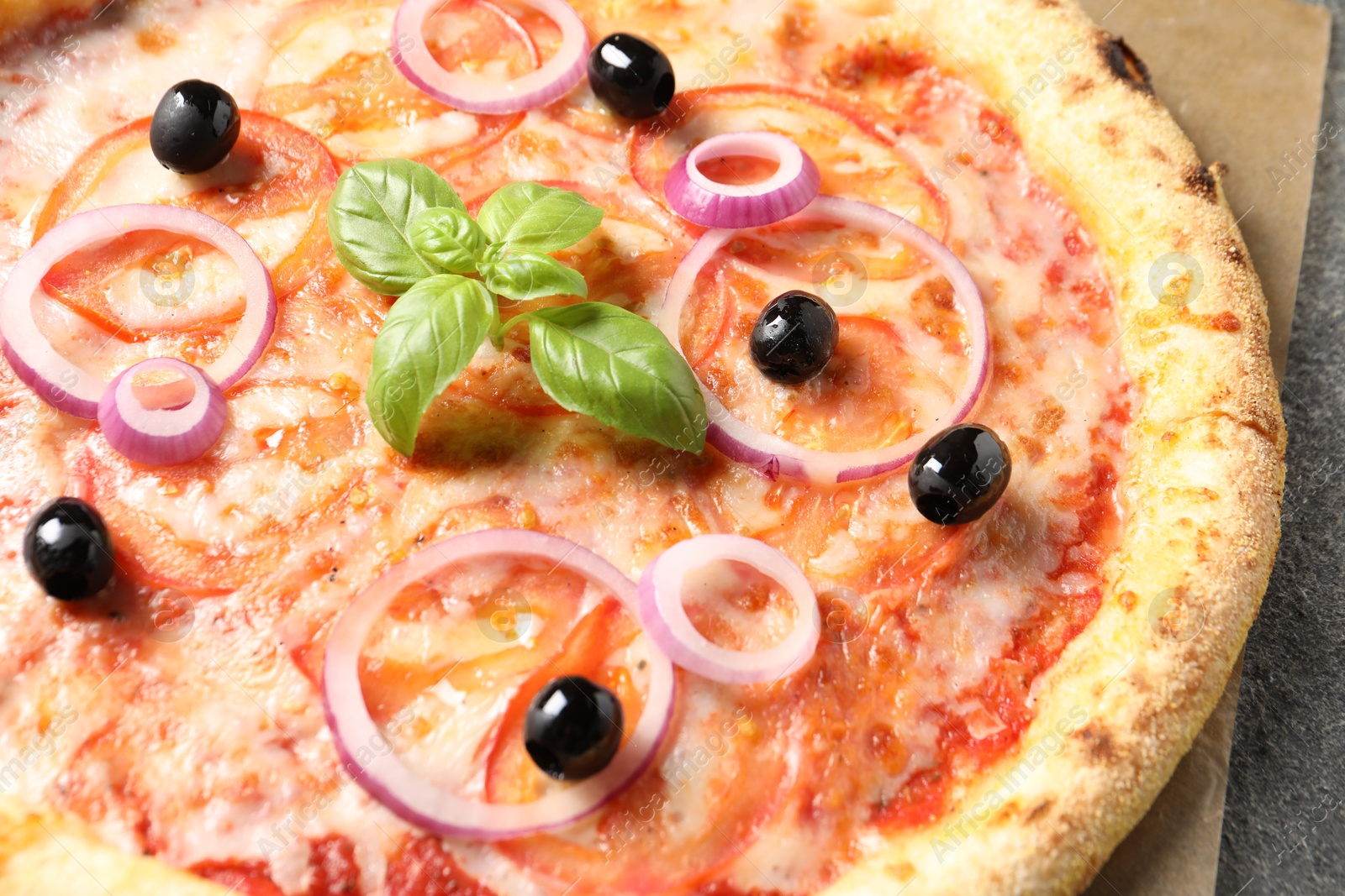 Photo of Delicious vegetarian pizza with fresh basil on table, closeup