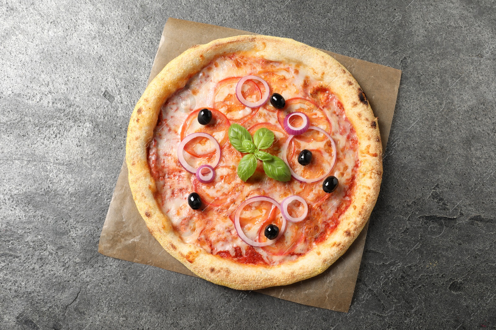 Photo of Delicious vegetarian pizza on grey table, top view