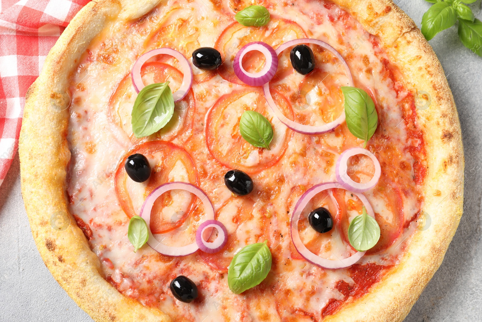 Photo of Delicious vegetarian pizza on light grey table, top view