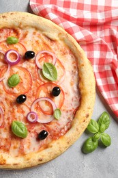 Photo of Delicious vegetarian pizza on light grey table, top view