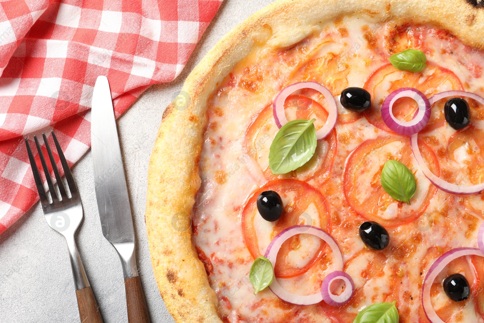 Photo of Delicious vegetarian pizza and cutlery on light grey table, top view