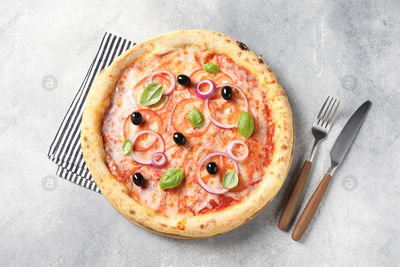 Photo of Delicious vegetarian pizza on light grey table, top view