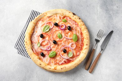 Photo of Delicious vegetarian pizza on light grey table, top view