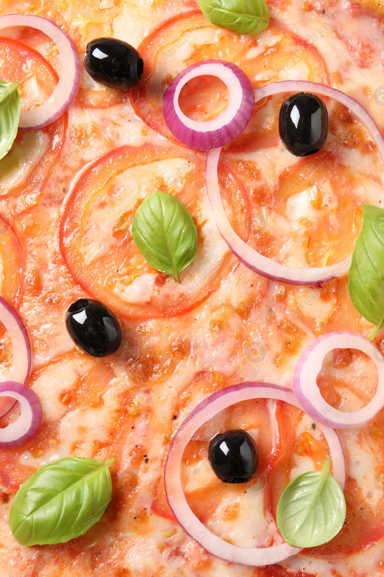 Photo of Delicious vegetarian pizza with basil as background, closeup