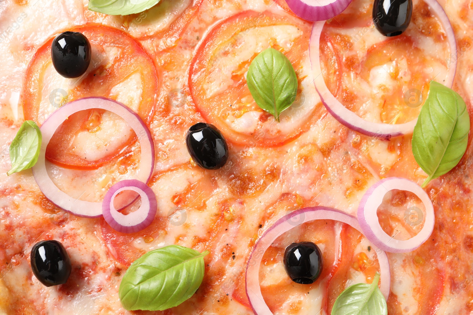 Photo of Delicious vegetarian pizza with basil as background, closeup