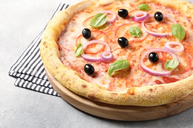 Photo of Delicious vegetarian pizza on light grey table, closeup