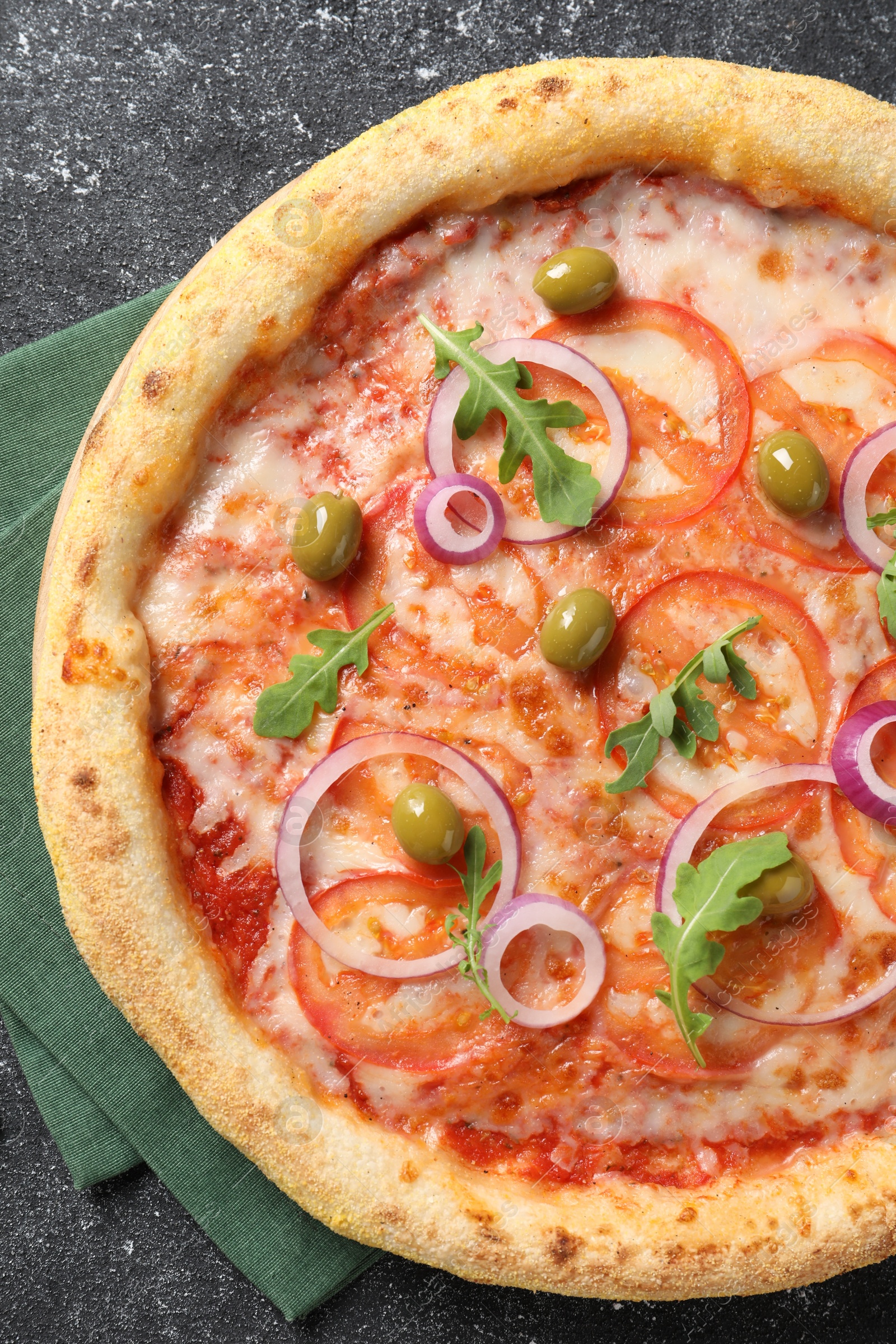 Photo of Delicious vegetarian pizza on black table, top view