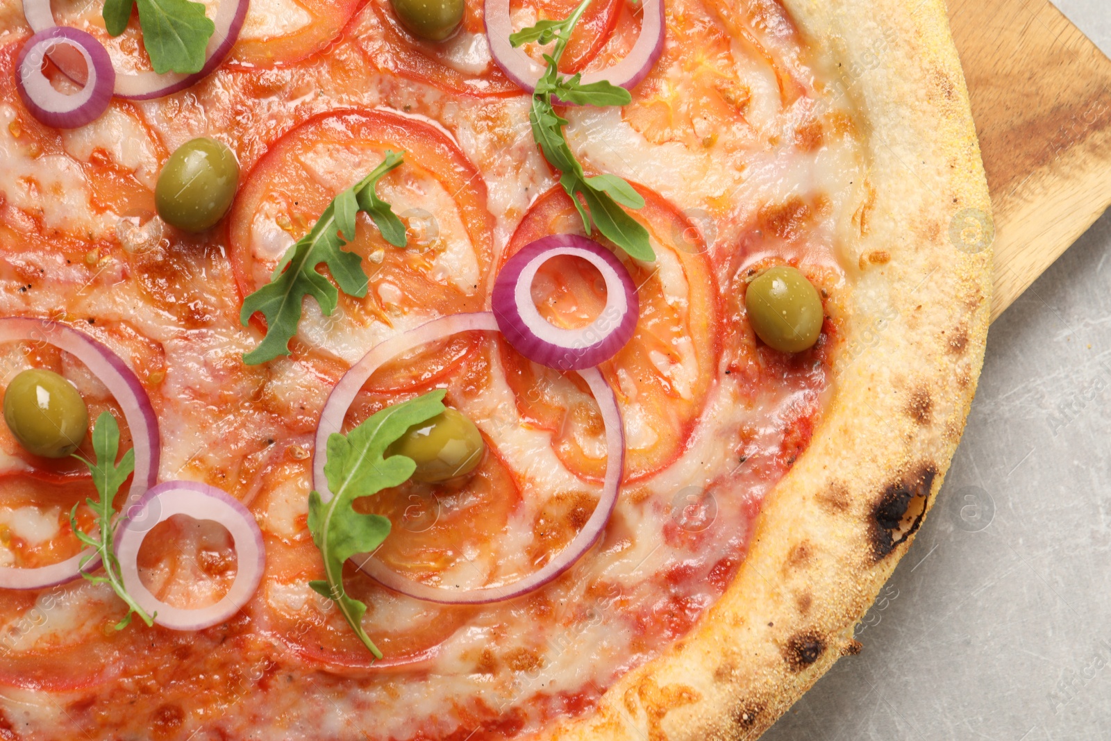 Photo of Delicious vegetarian pizza on light grey background, closeup