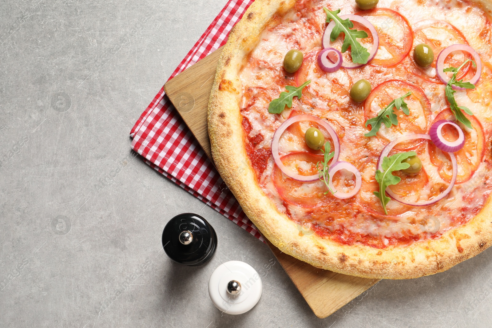 Photo of Delicious vegetarian pizza, salt and pepper on light grey background, top view