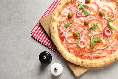 Photo of Delicious vegetarian pizza, salt and pepper on light grey background, top view