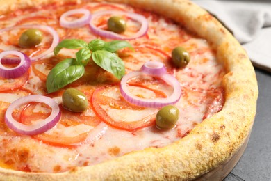 Photo of Delicious vegetarian pizza on black table, closeup