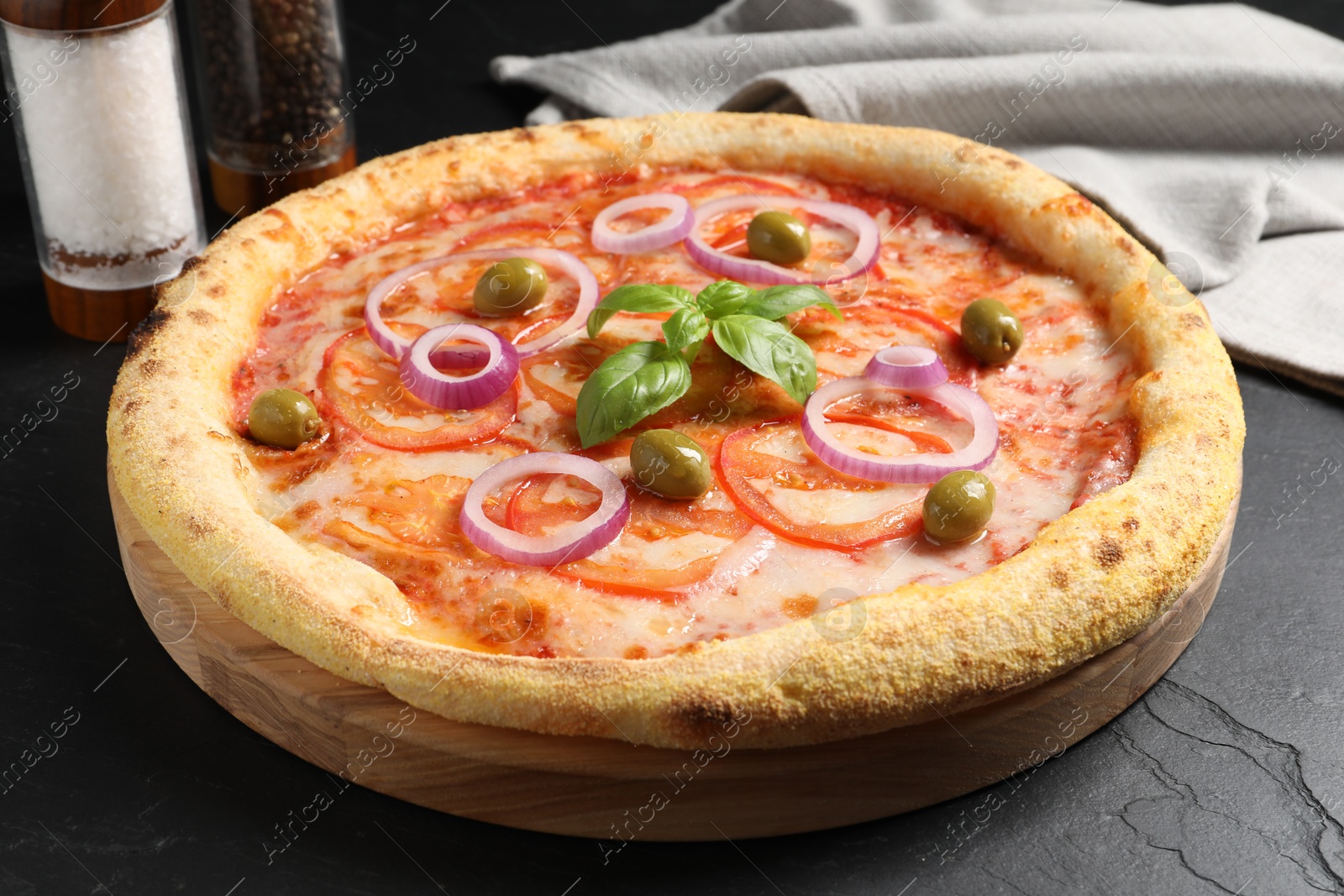 Photo of Delicious vegetarian pizza on black table, closeup