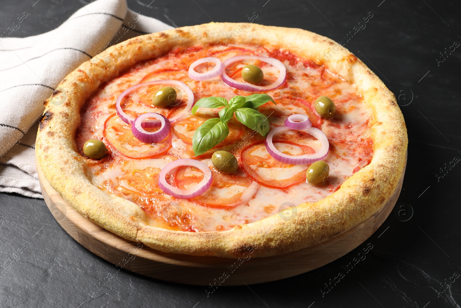 Photo of Delicious vegetarian pizza on black table, closeup