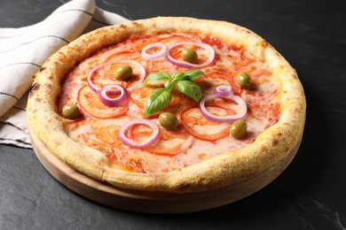 Photo of Delicious vegetarian pizza on black table, closeup