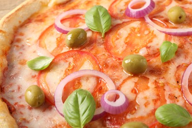 Photo of Delicious vegetarian pizza with basil as background, closeup