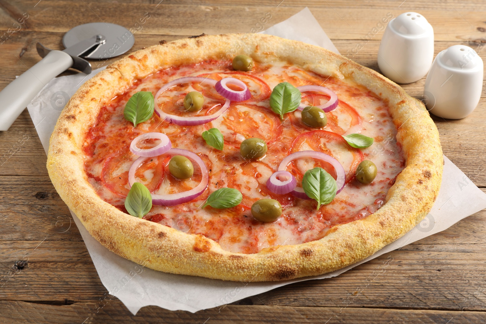 Photo of Delicious vegetarian pizza on wooden table, closeup