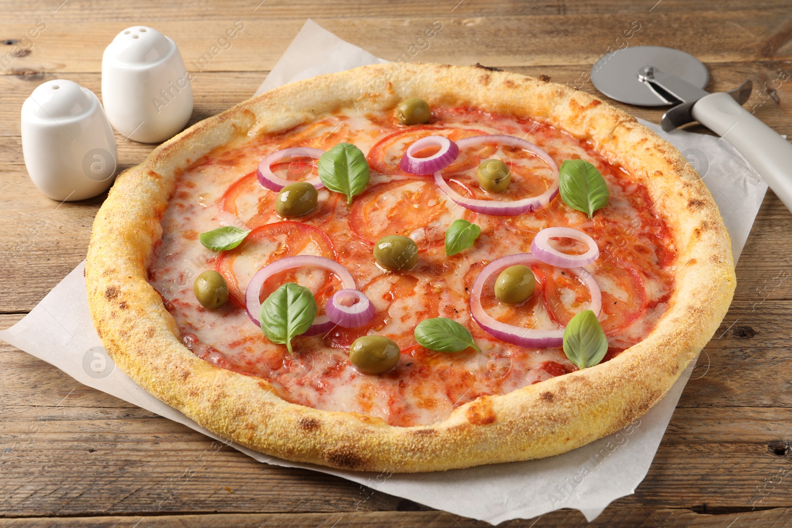 Photo of Delicious vegetarian pizza on wooden table, closeup