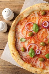 Photo of Delicious vegetarian pizza on wooden table, top view