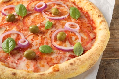 Photo of Delicious vegetarian pizza on wooden table, closeup