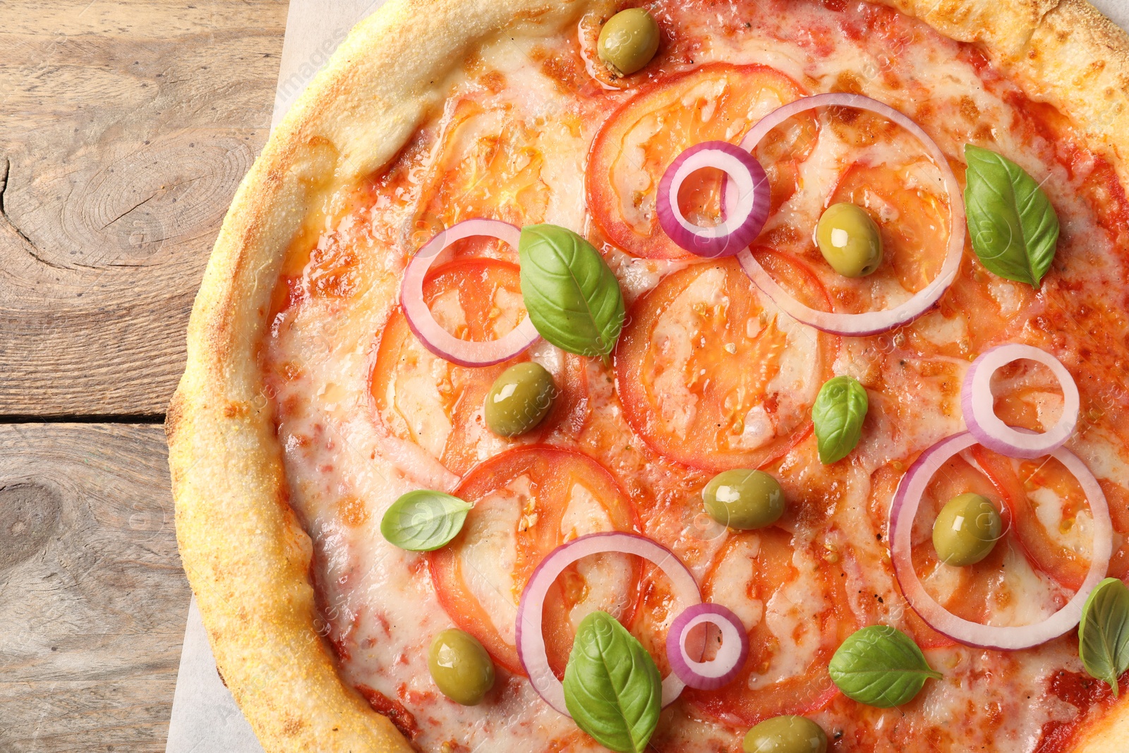 Photo of Delicious vegetarian pizza on wooden table, closeup