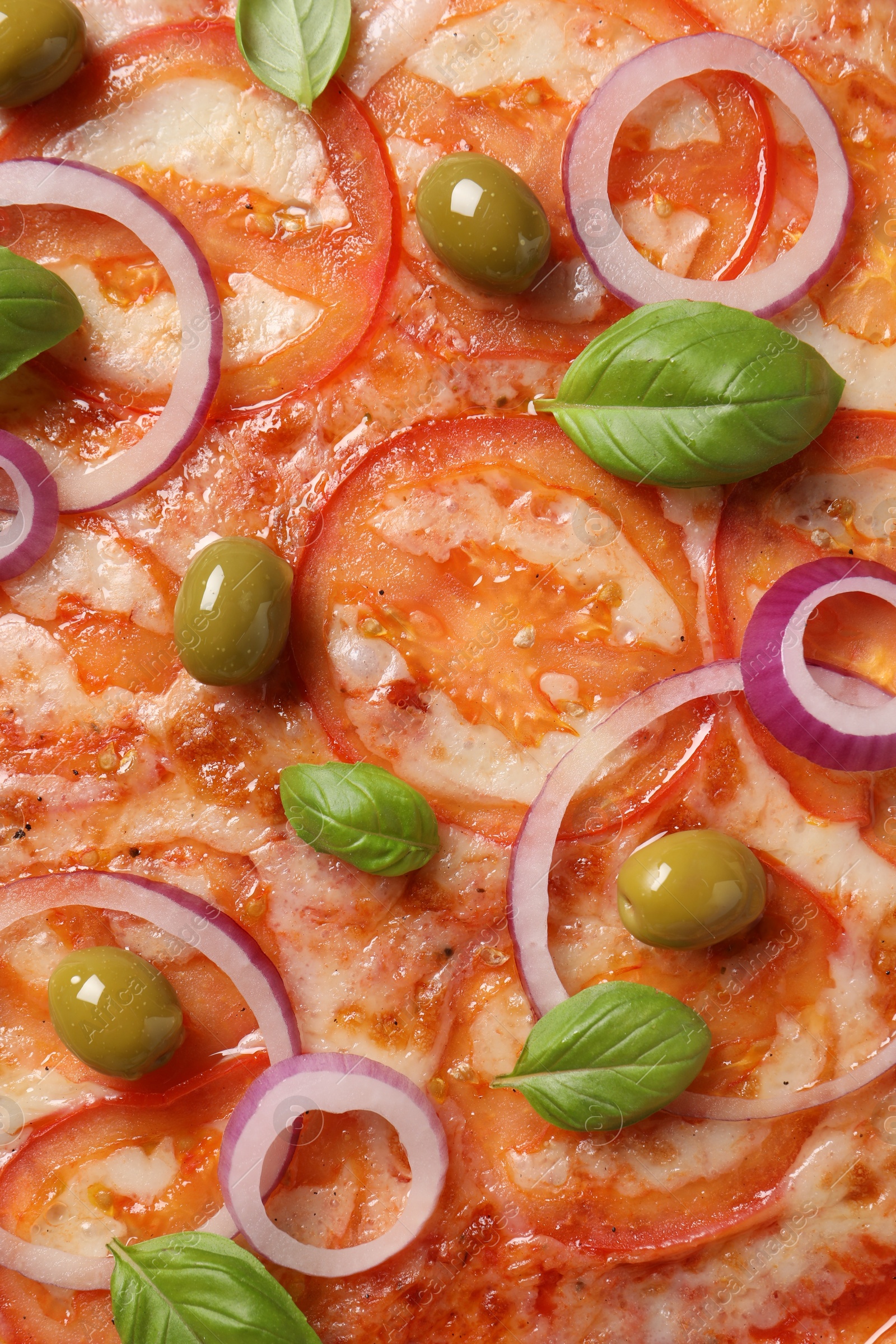 Photo of Delicious vegetarian pizza with basil as background, closeup