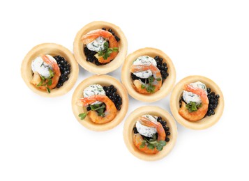 Delicious canapes with shrimps and black caviar isolated on white, top view