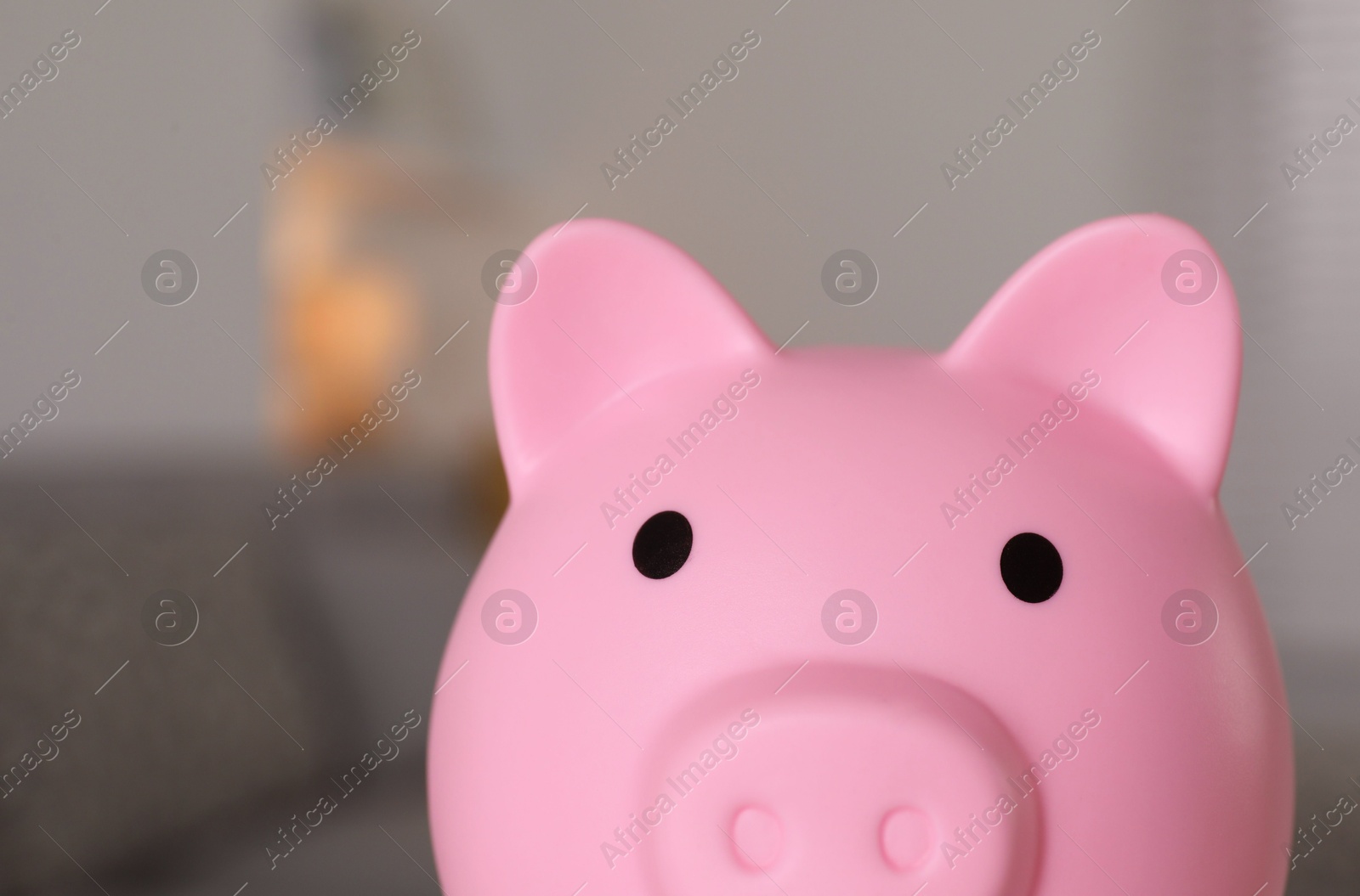 Photo of Pink piggy bank on blurred background, closeup