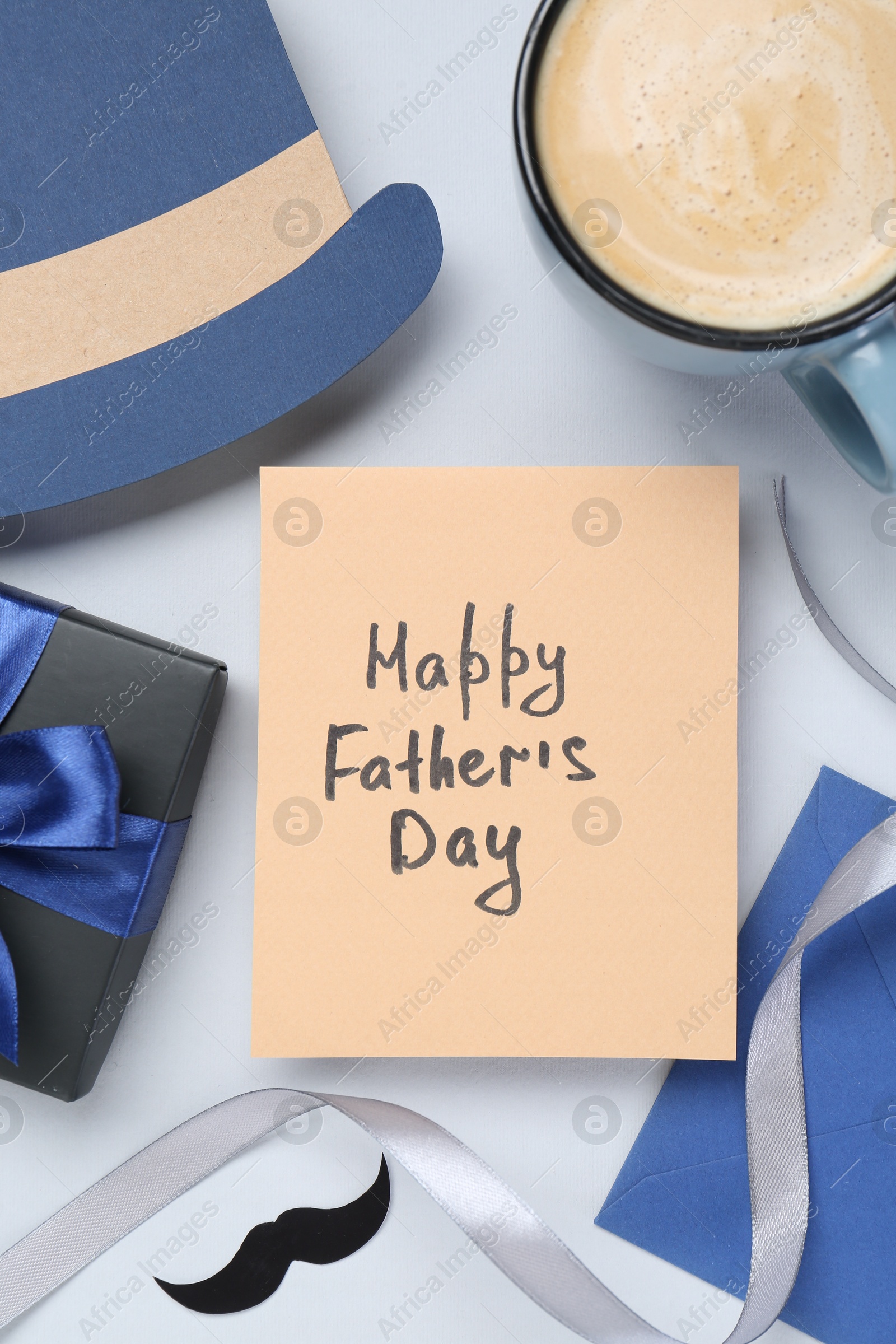 Photo of Greeting card with phrase Happy Father's Day, coffee, gift, paper hat and moustache on light background, flat lay